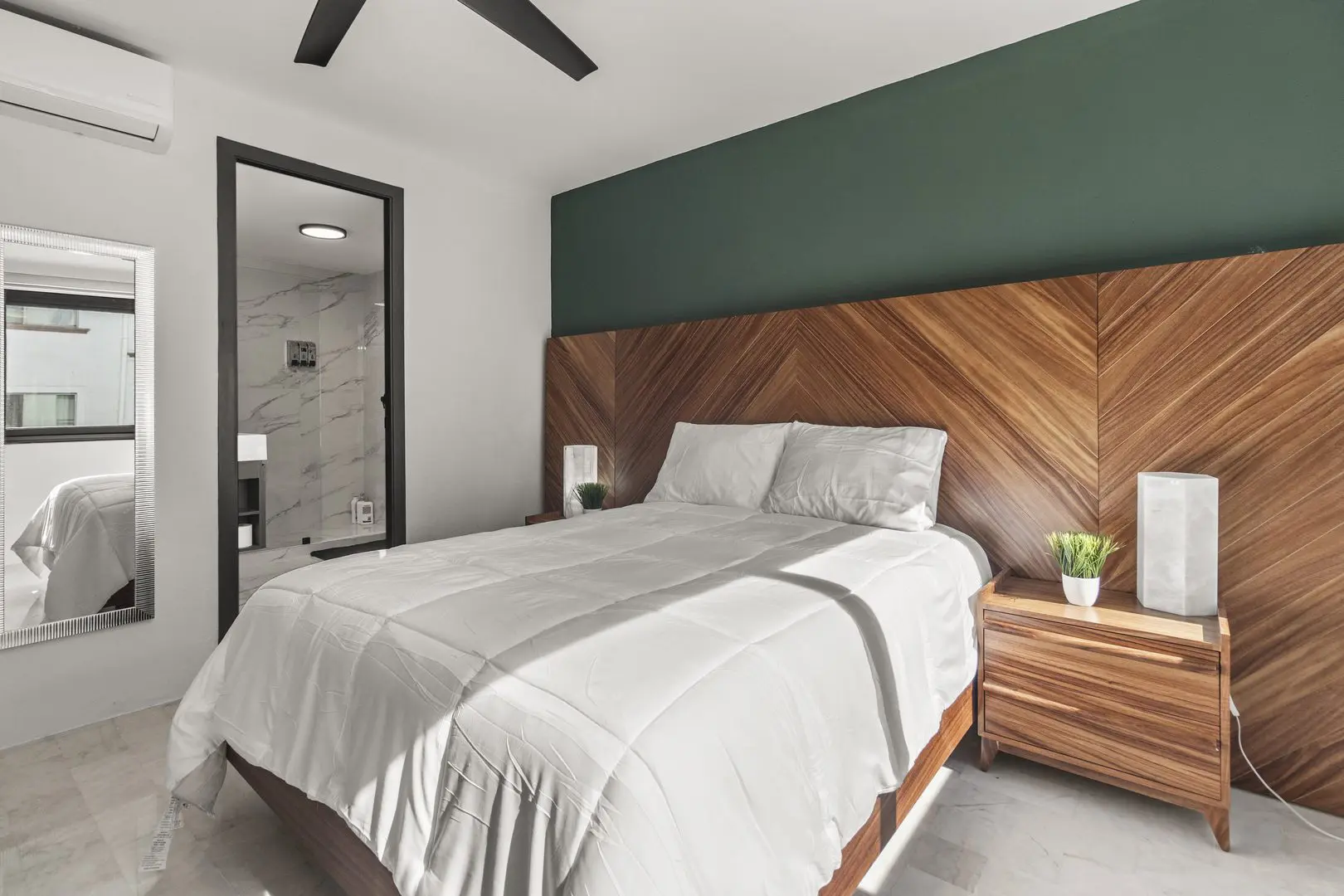 Modern bedroom with wooden headboard and decor.